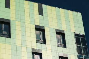 Office building exterior with green and yellow panels