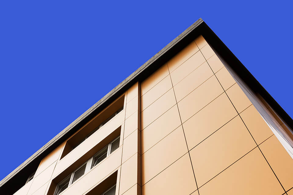 Exterior view of an office with orange composite panels